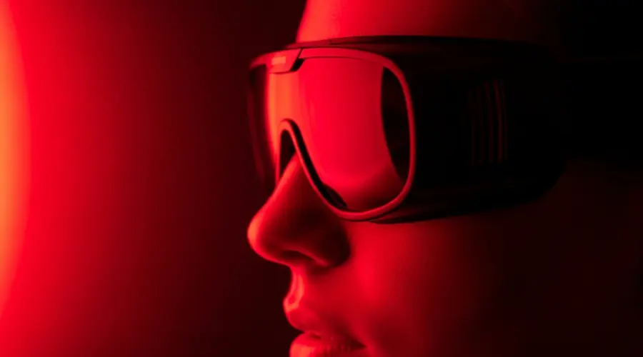 Person wearing protective blackout goggles during a red light therapy session to ensure eye safety.